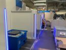 Modern Industrial Workshop Area With Equipment and Blue Neon Lighting