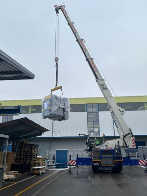 Large Industrial Crane Lifting Heavy Equipment at a Construction Site