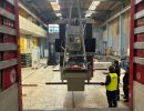 Industrial Machine Lifted by Crane in a Warehouse Environment