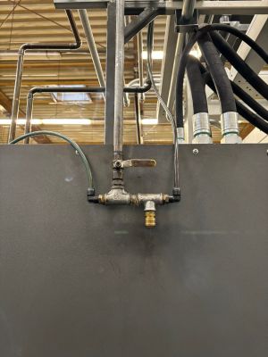 Industrial Pipe System with Valves and Connectors in a Workshop Setting