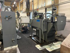 Industrial Machinery in Operation With Worker Performing Maintenance in Factory Setting