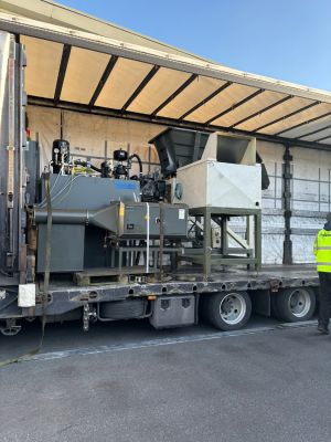 Industrial Machinery Loaded Onto Open Truck Displaying Transport Process