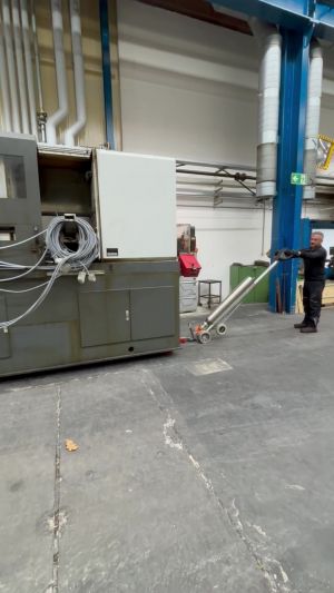 Worker Operates Machinery In Industrial Factory with Specialized Tools for Equipment Handling