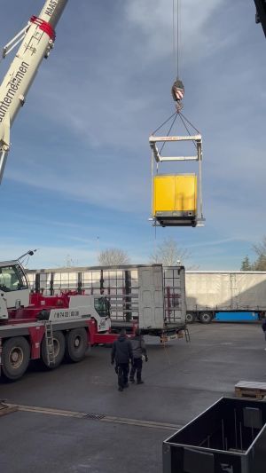 Construction Equipment Being Lifted by Crane at an Industrial Site