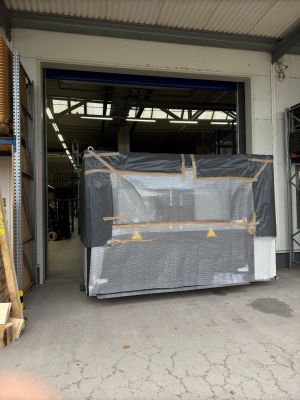 Large Wrapped Industrial Equipment Near Loading Dock of Warehouse Facility