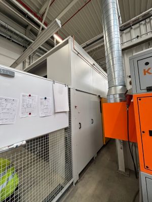 Industrial Equipment Inside a Factory With Metal Duct and Maintenance Documents