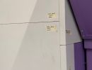 Minimalist Wall Design Featuring Utility Notes and Contrasting Purple Panel