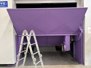 Purple Industrial Equipment Inside Facility With Metallic Ladder Positioned Nearby
