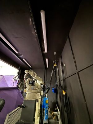 Industrial Robotic Arm in a Workshop with Technical Components and Wiring Visible