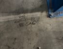 Markings Highlight Measurements on a Workshop Floor Beside Metal Base