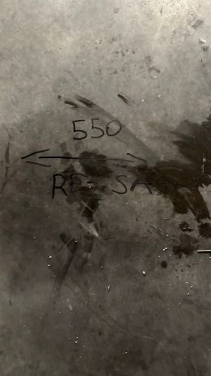 Number and Notes Scrawled on a Metalic Surface with Light Marks