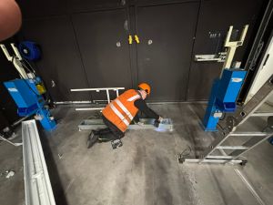 Technician Working on Industrial Equipment in a Workshop Environment