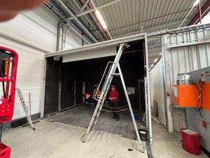 Worksite Scene with Technicians and Ladder in Industrial Environment