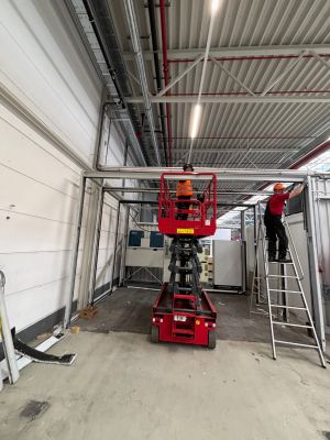 Construction Workers Using Scissor Lift and Ladder in Industrial Environment