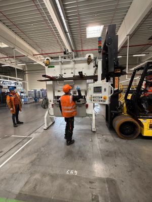 Industrial Workers Operating Machinery in a Mechanical Facility for Logistics