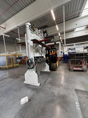 Industrial Warehouse Scene Featuring Machinery and Equipment with Worker Present