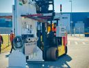 Forklift Handling Industrial Machinery Outdoors on a Bright Sunny Day