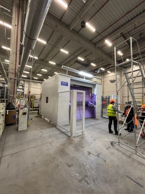 Industrial Manufacturing Facility With Workers and Machinery Under Bright Lighting