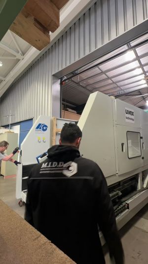 Technicians Operating Machinery in an Industrial Workshop with Modern Equipment