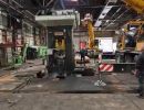 Industrial Machinery Setup in a Factory With Workers and Heavy Equipment
